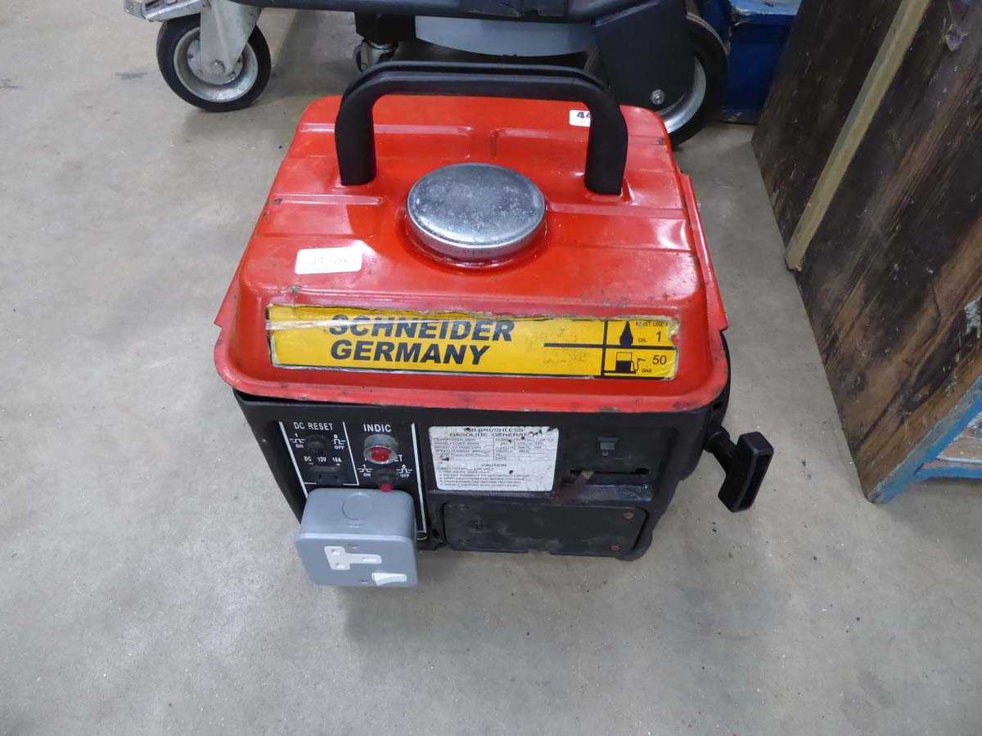 Small red petrol powered generator