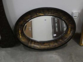 Oval bevelled mirror in oriental lacquered frame Slight scratches and chips to frame (See images