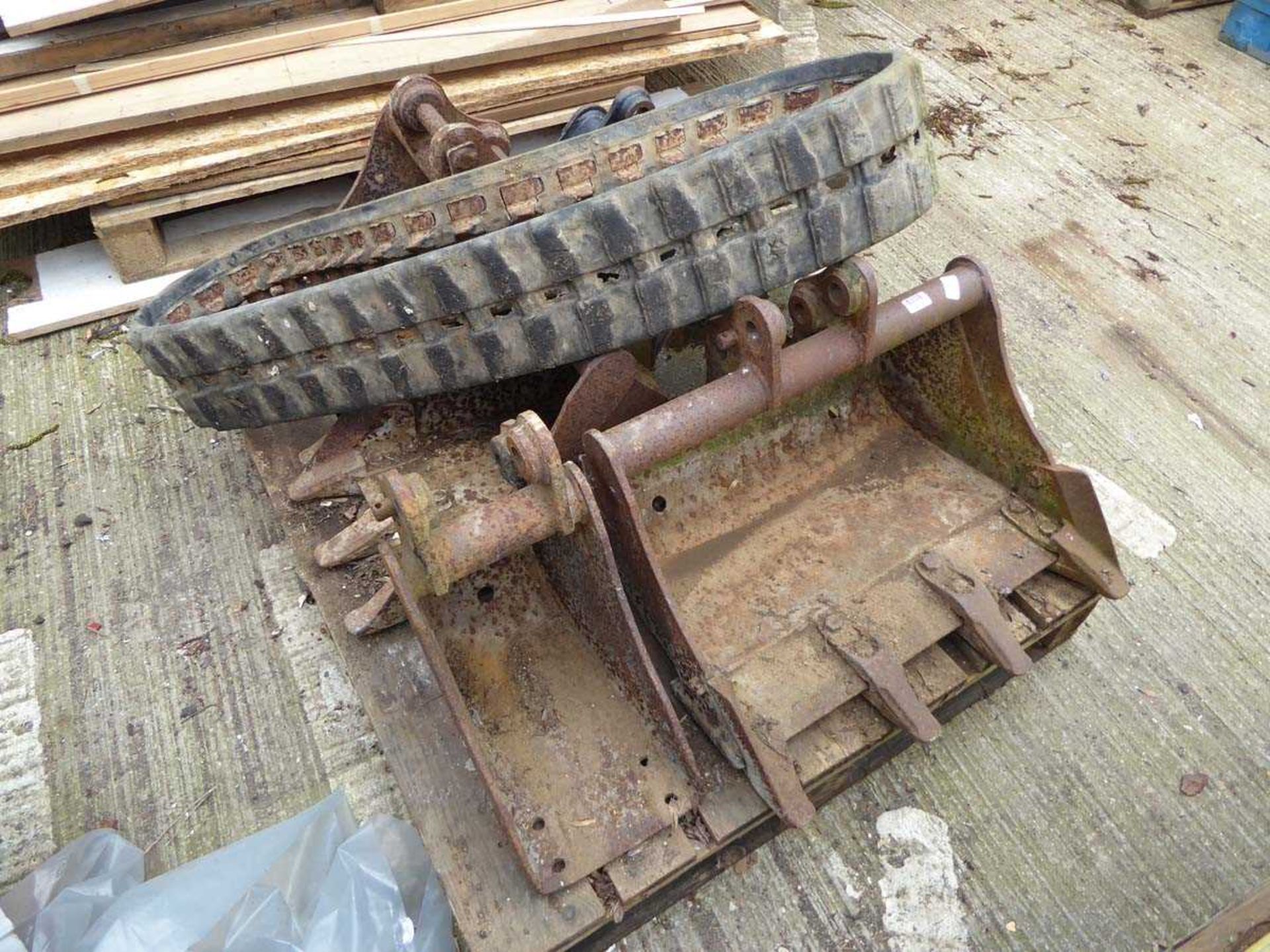 Pallet containing digger buckets and digger track