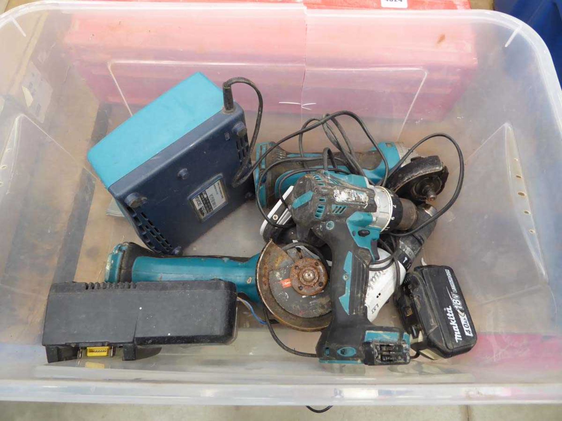 Plastic box containing Makita drills, angle grinders, two chargers and one battery