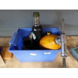 Box containing vintage oil bottles, cans and pumps