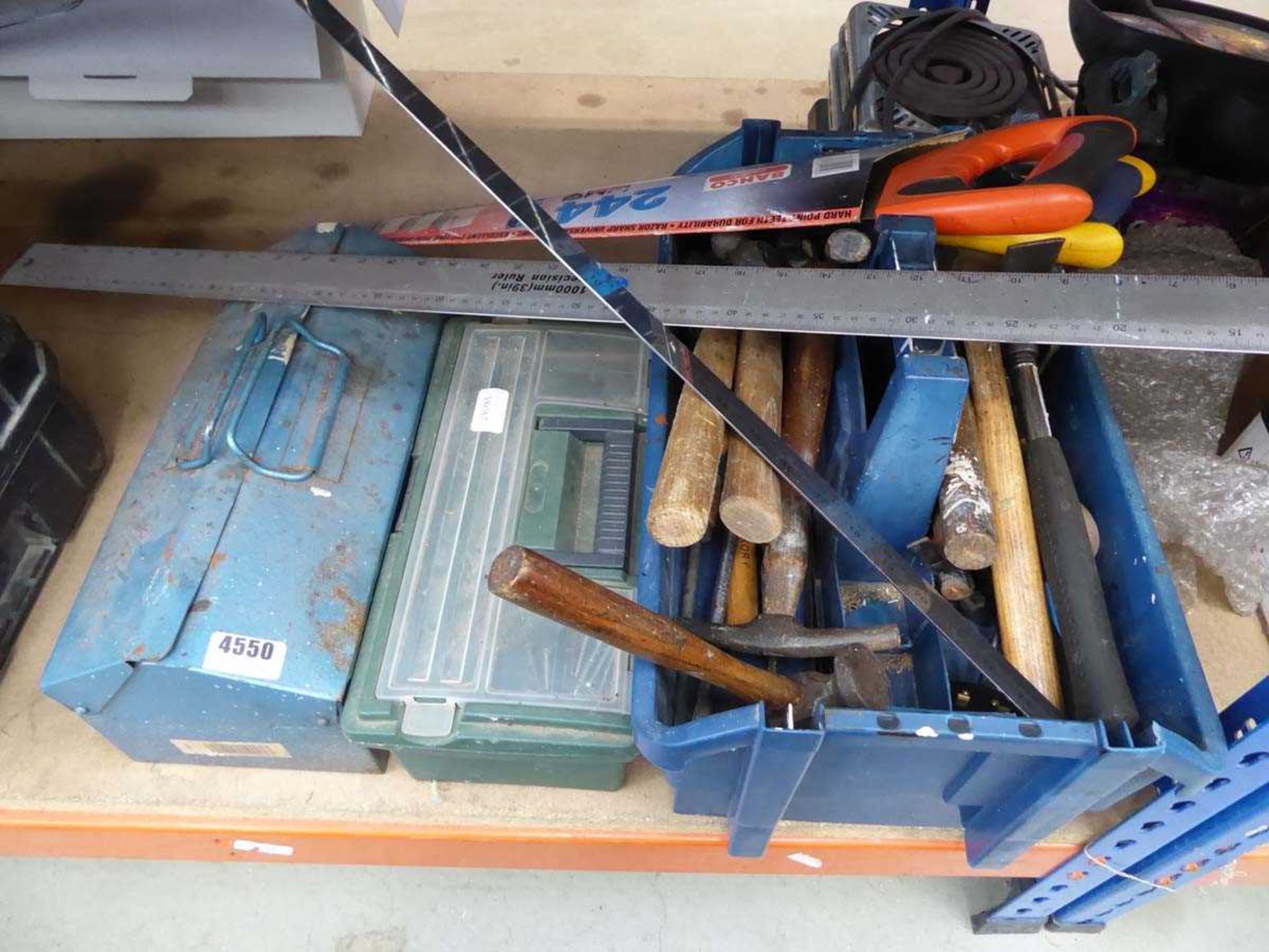 Quarter of an under bay containing various toolboxes with saws, hammers, measures, etc