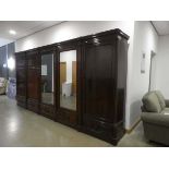 An imposing sectional Victorian (and later) rosewood five-door wardrobe with two mirrored doors.