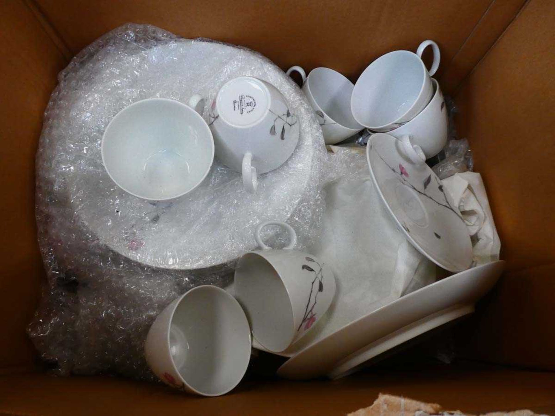 Box containing a quantity of floral patterned crockery