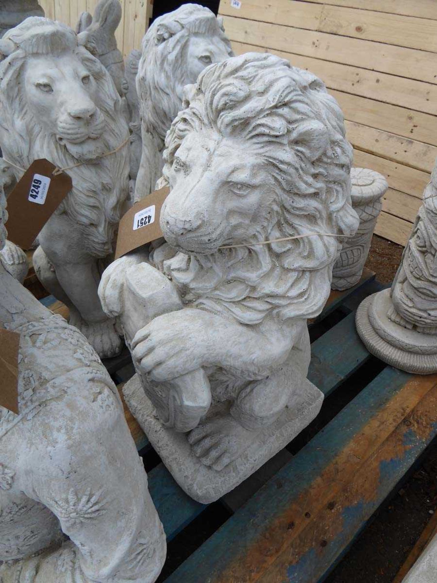 Large concrete lion with a welcome plaque