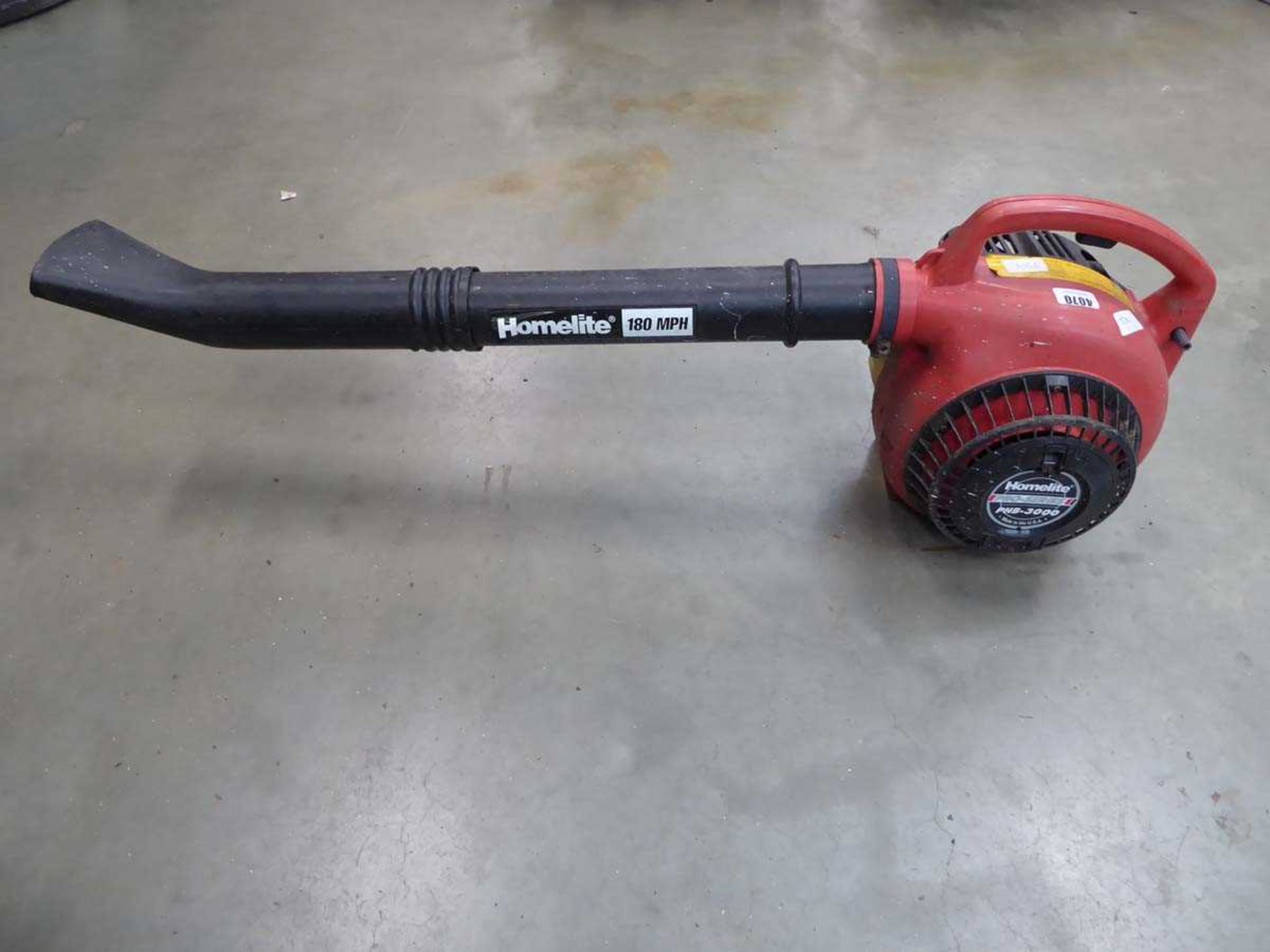 Homelite red petrol powered leaf blower