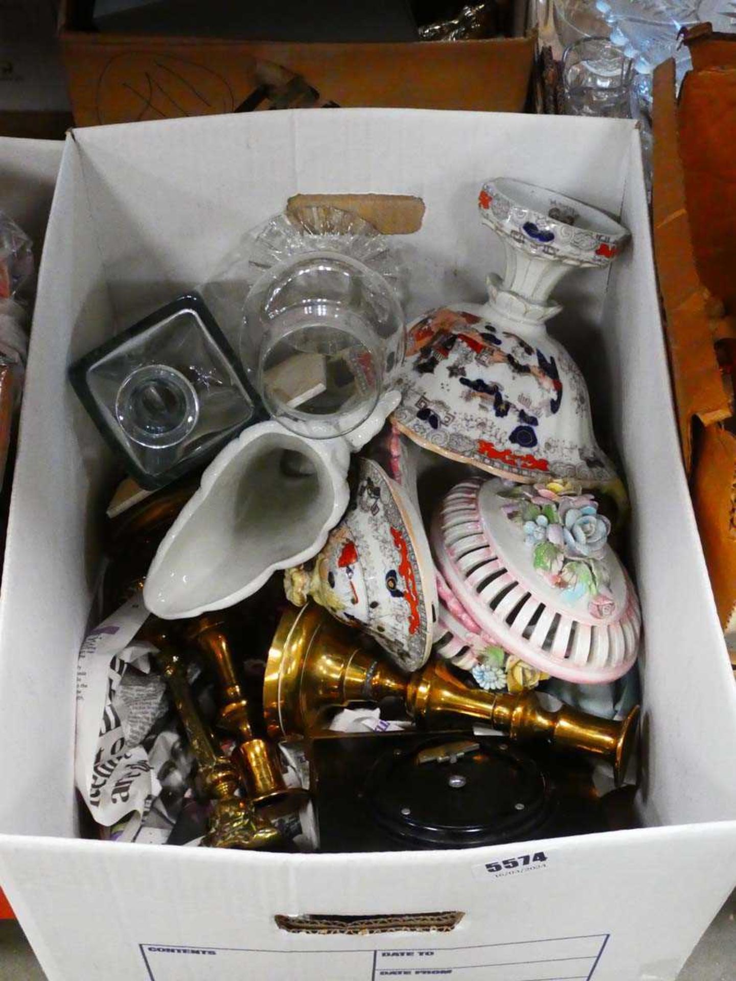 Box containing brass candlesticks, wine glasses, clock and general china