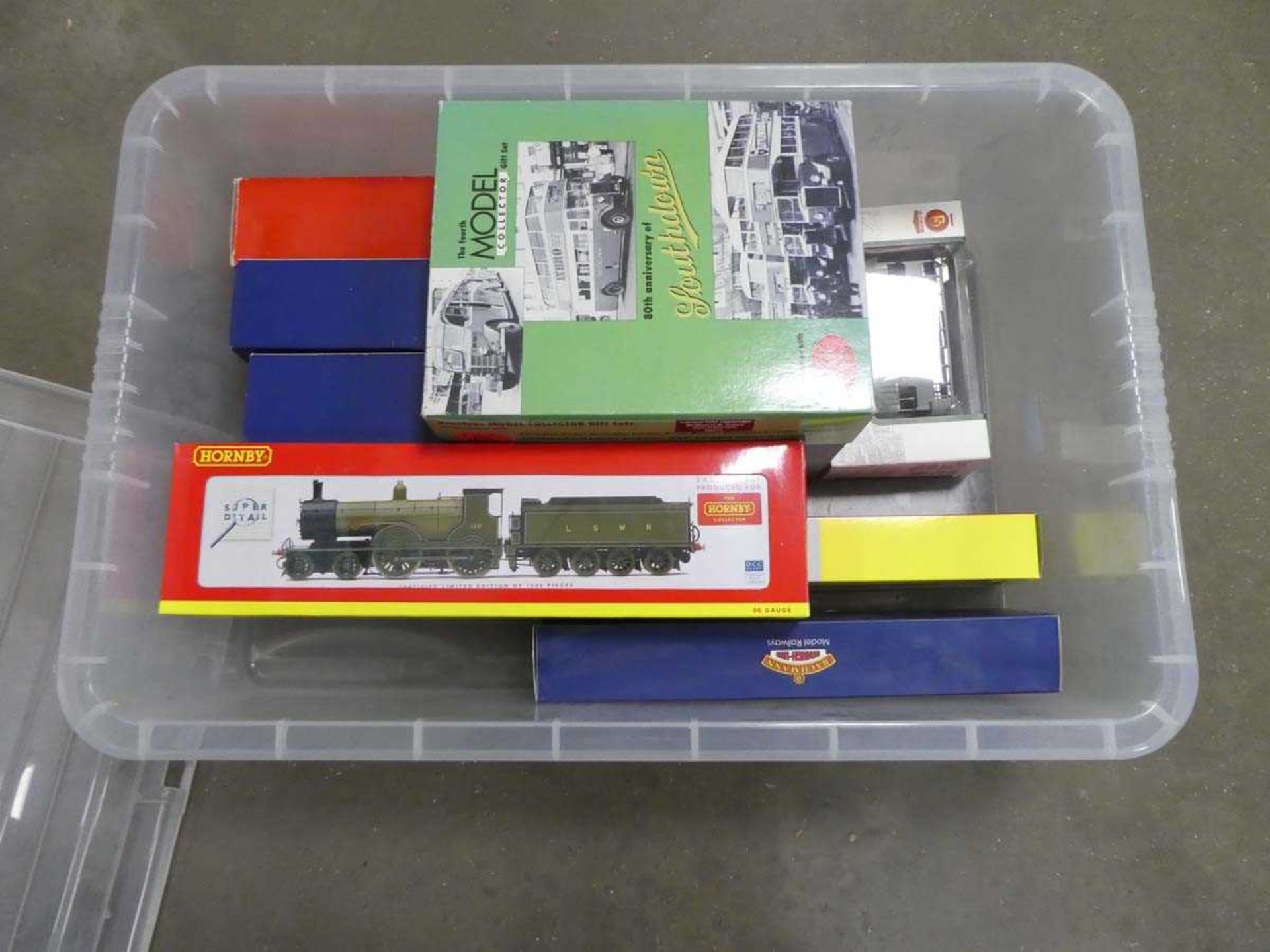 Box containing model buses and trains in original packaging