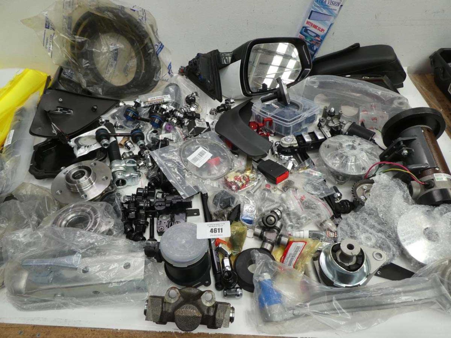 +VAT Large box containing vehicles spare parts including wing mirrors, wheel nuts, wheel hubs,