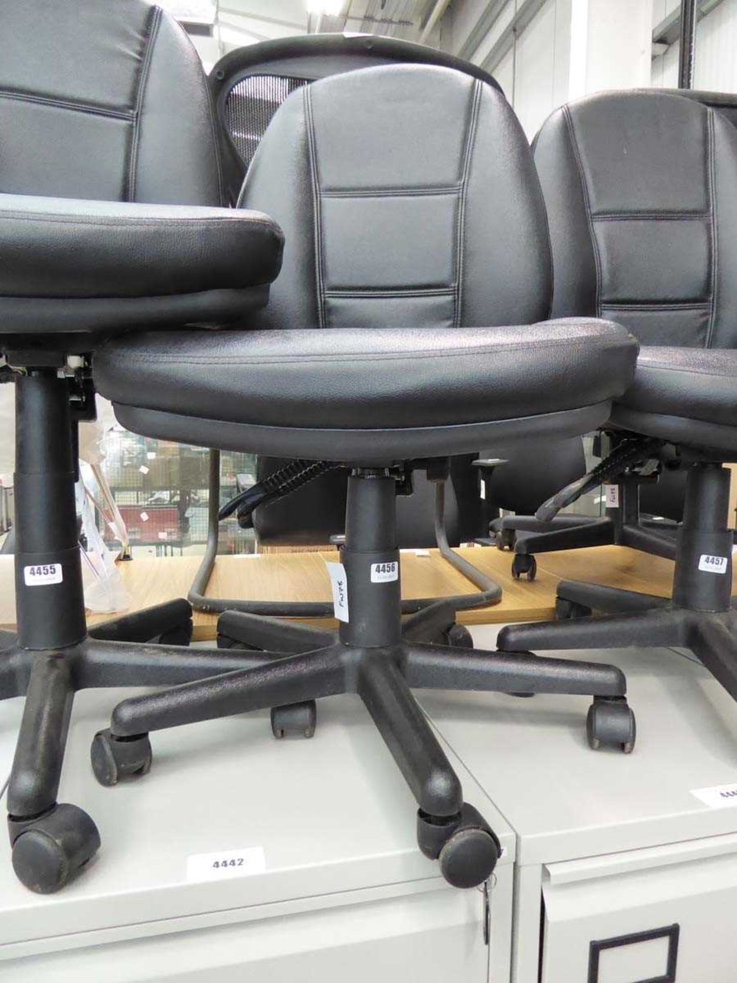 Black office operators chair on black base