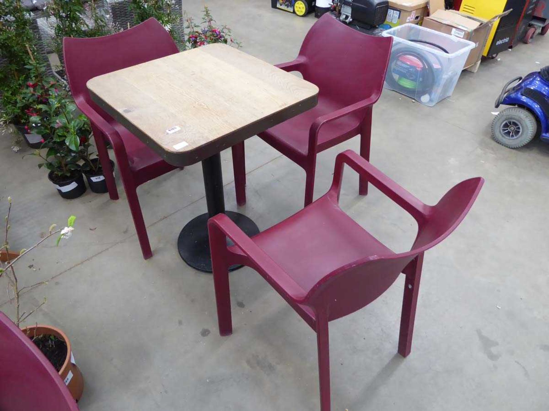 Slattted wood effect bistro table with 3 purple stacking plastic chairs