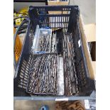 Black plastic crate of assorted drill bits