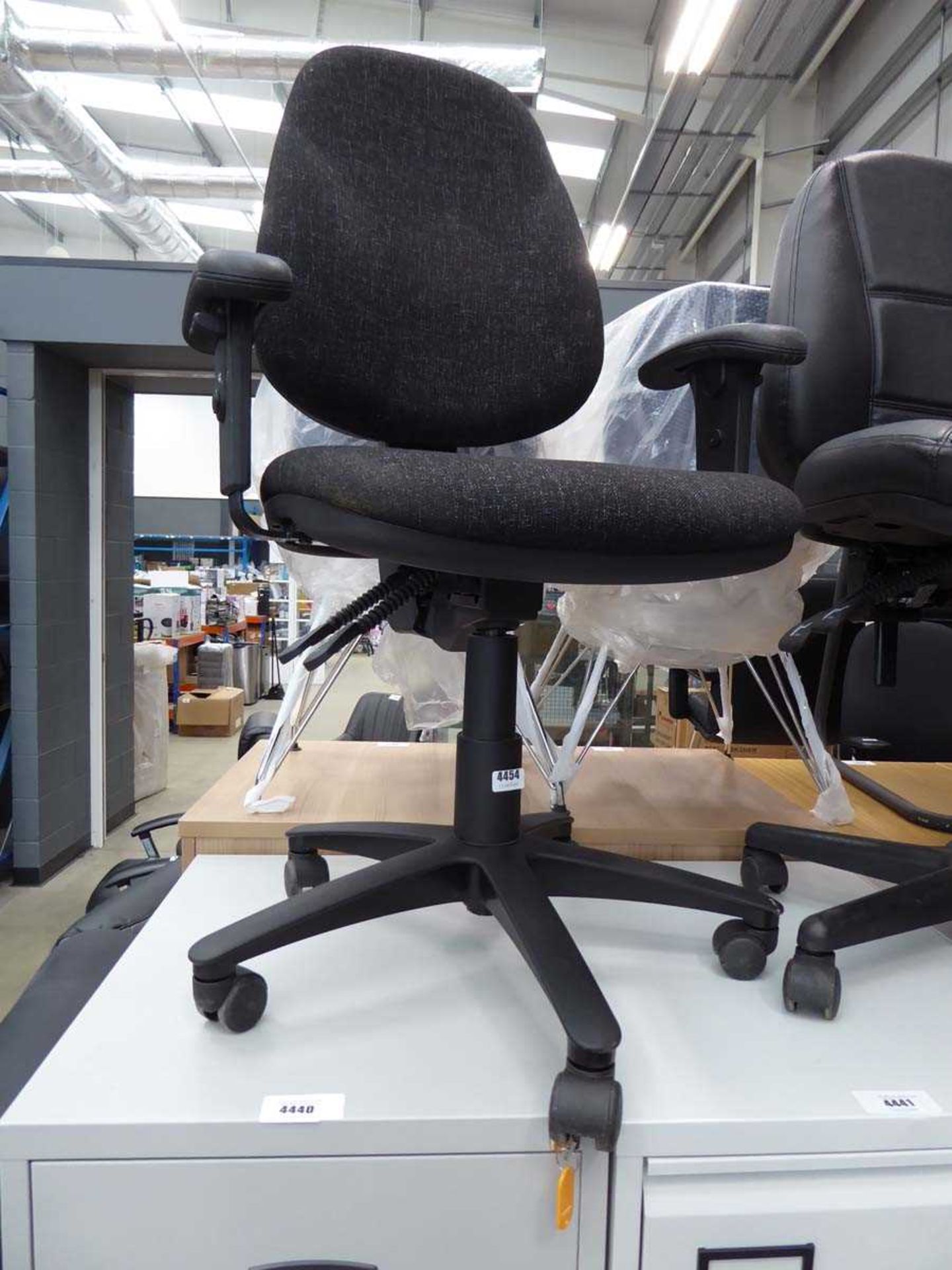 Black cloth office swivel armchair on black base