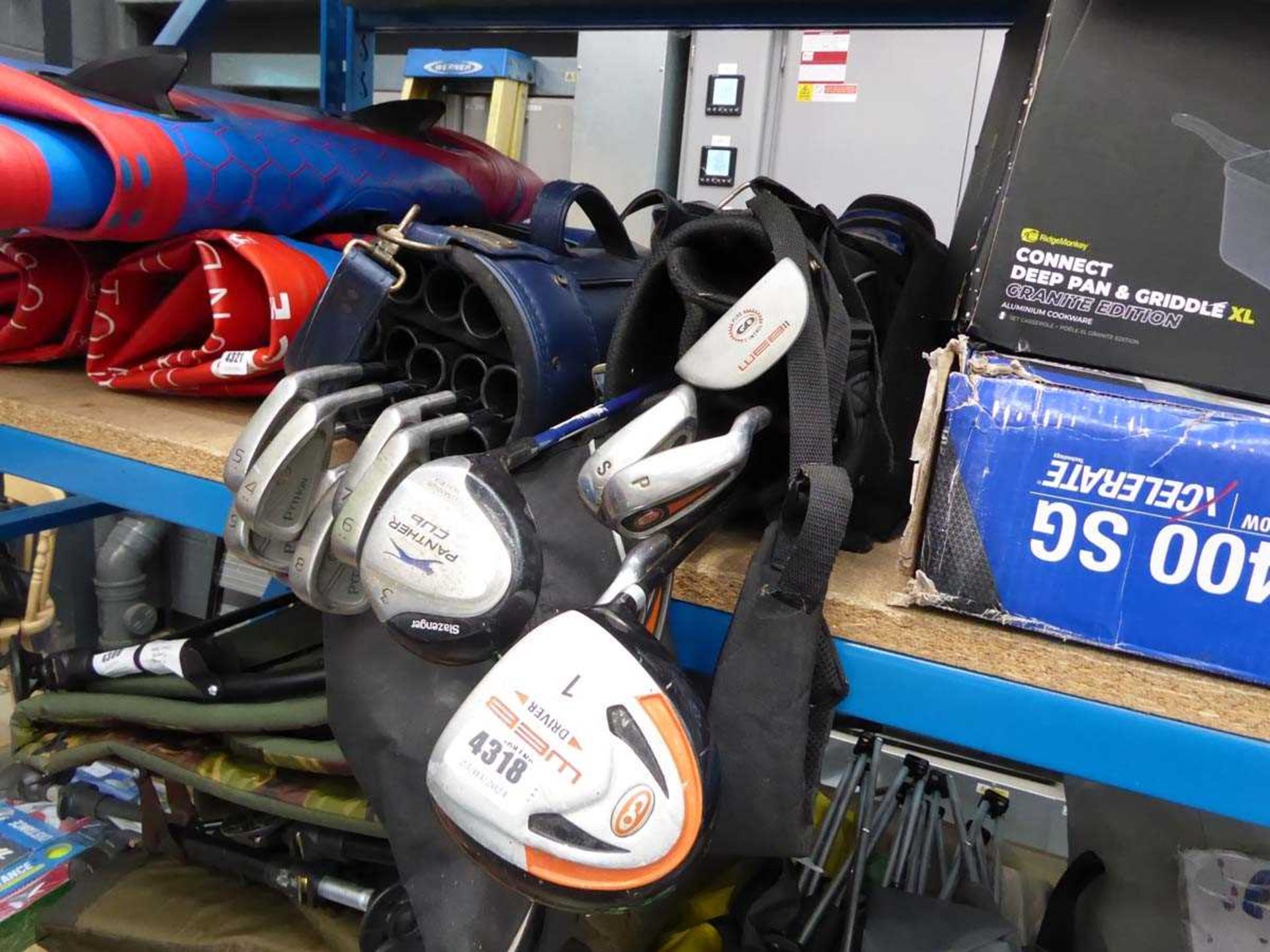 Two blue golf bags with assorted clubs