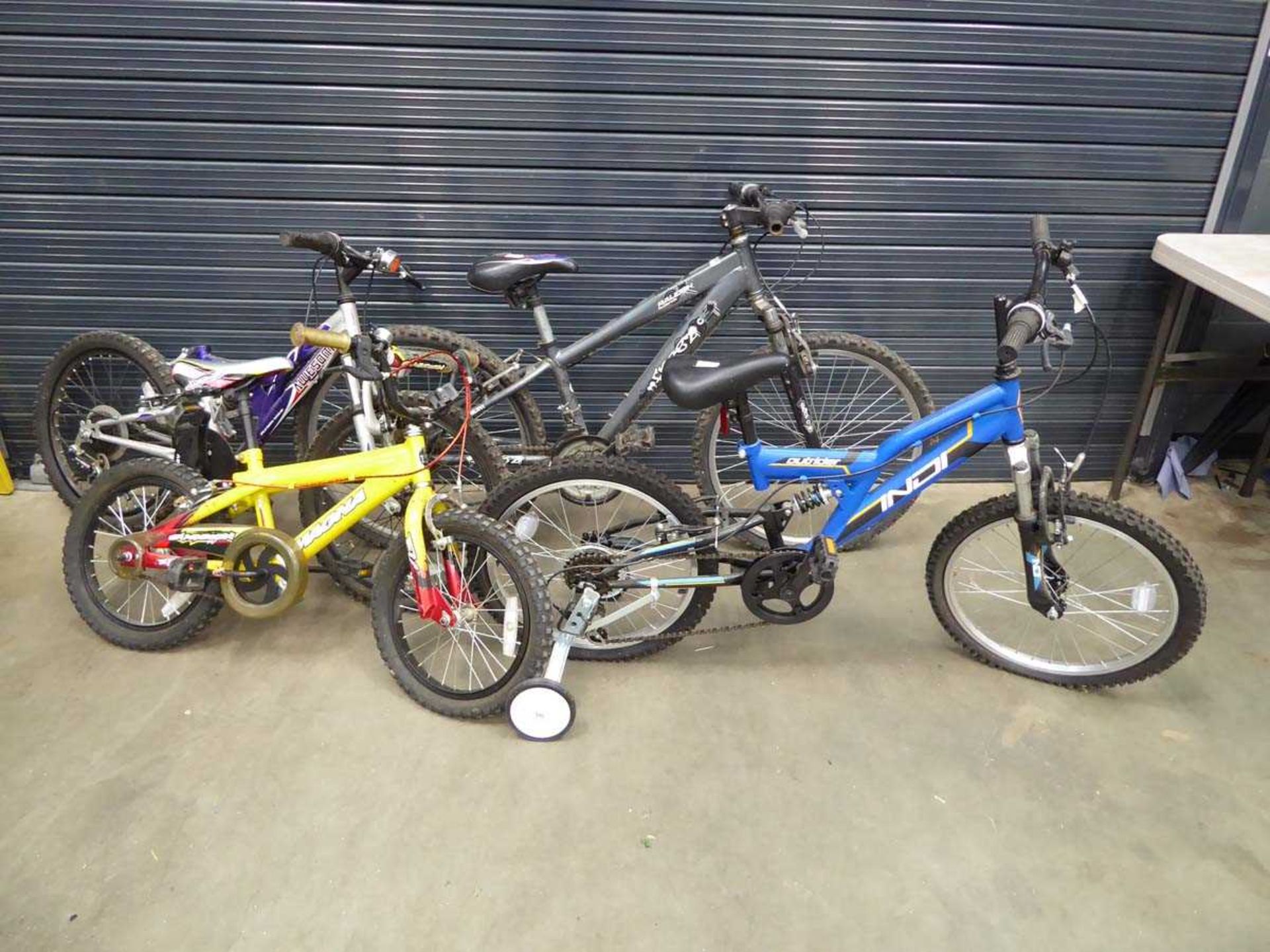 Four assorted bikes, to include child's yellow bike, blue BMX, Raleigh grey mountain bike, child's