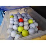 Plastic crate of assorted golf balls