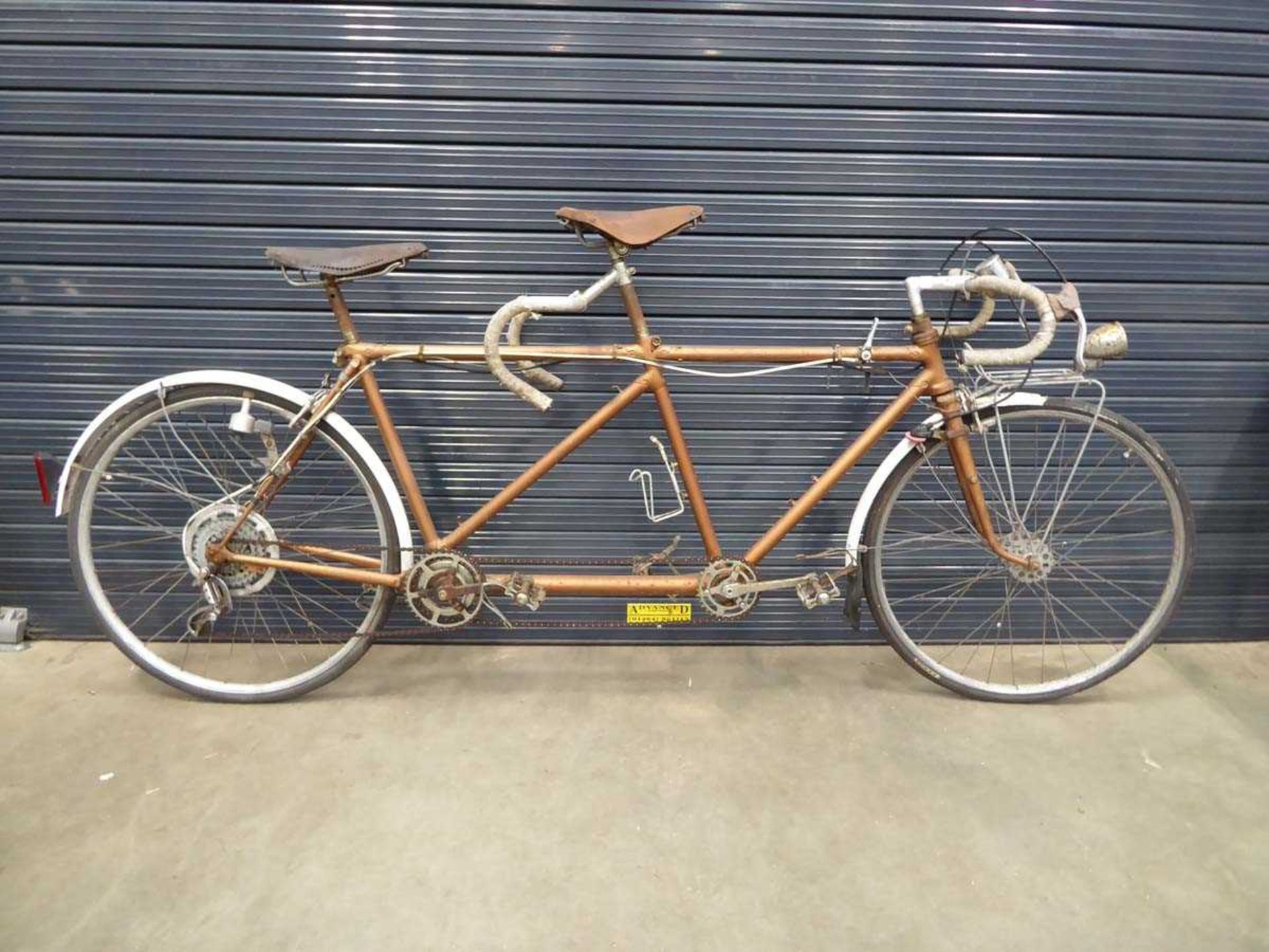 Brown tandem racing bike with Brooks saddles