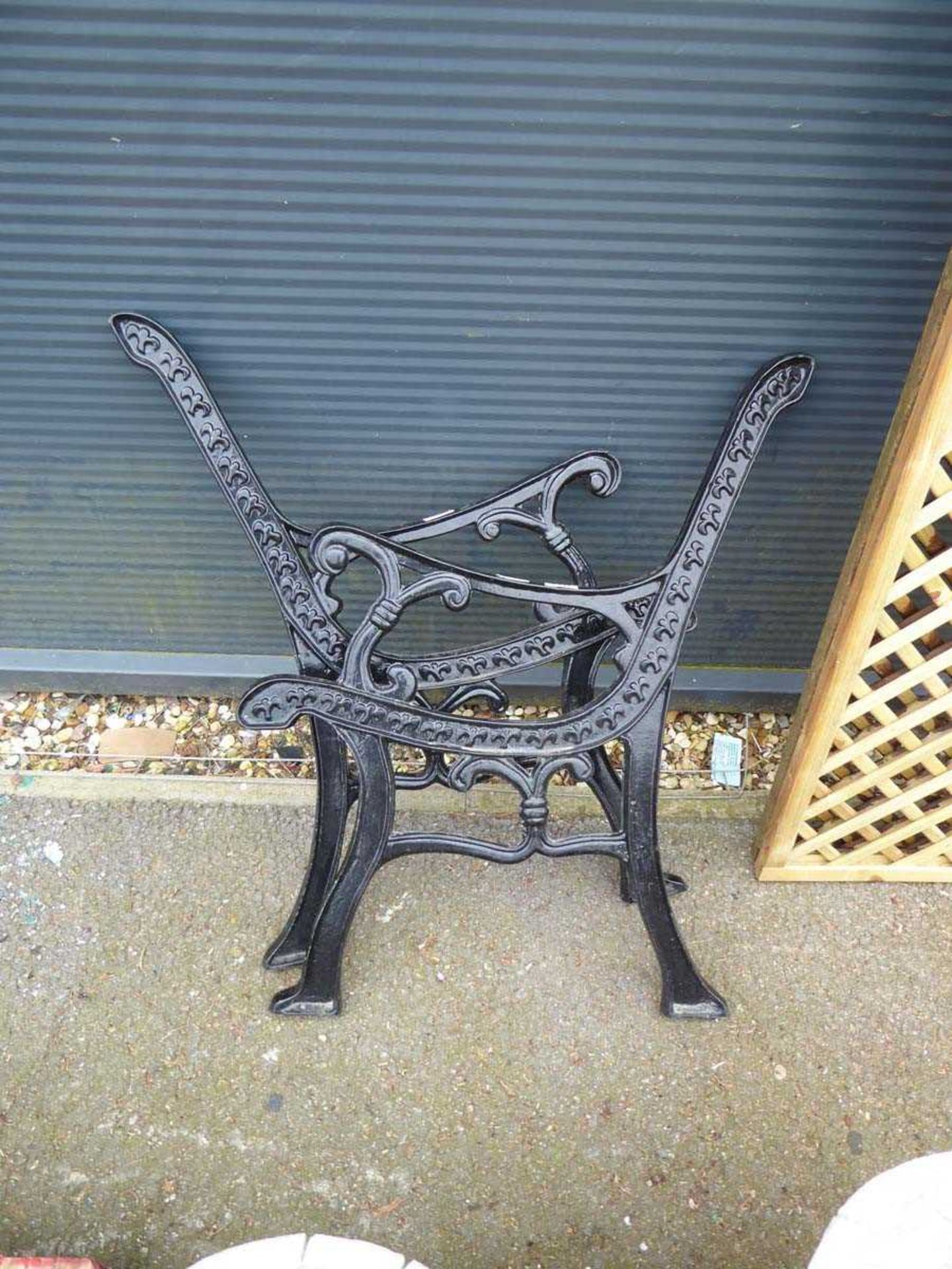 Pair of black painted wrought iron bench ends