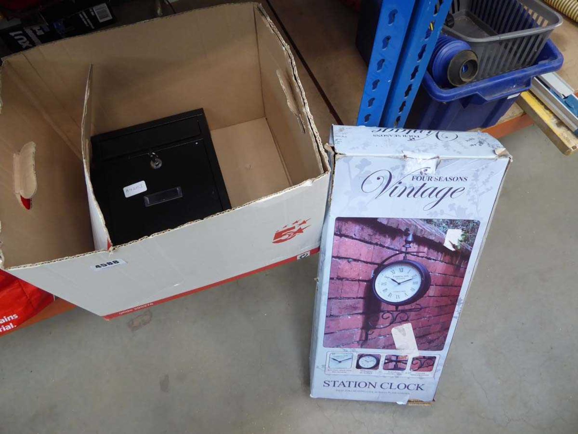 Box containing letter box and a wall clock