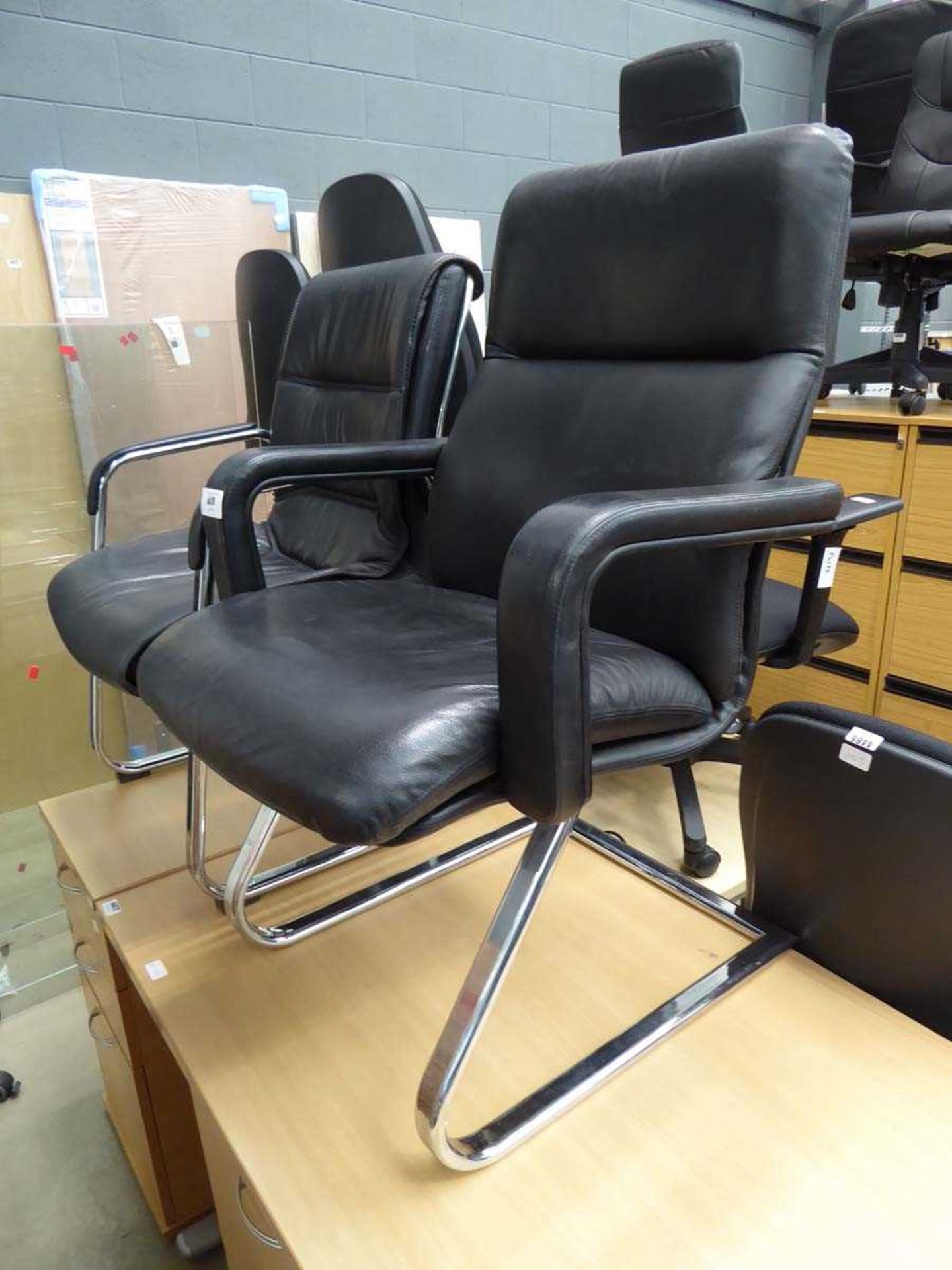 2 x black office slide chairs on chrome bases