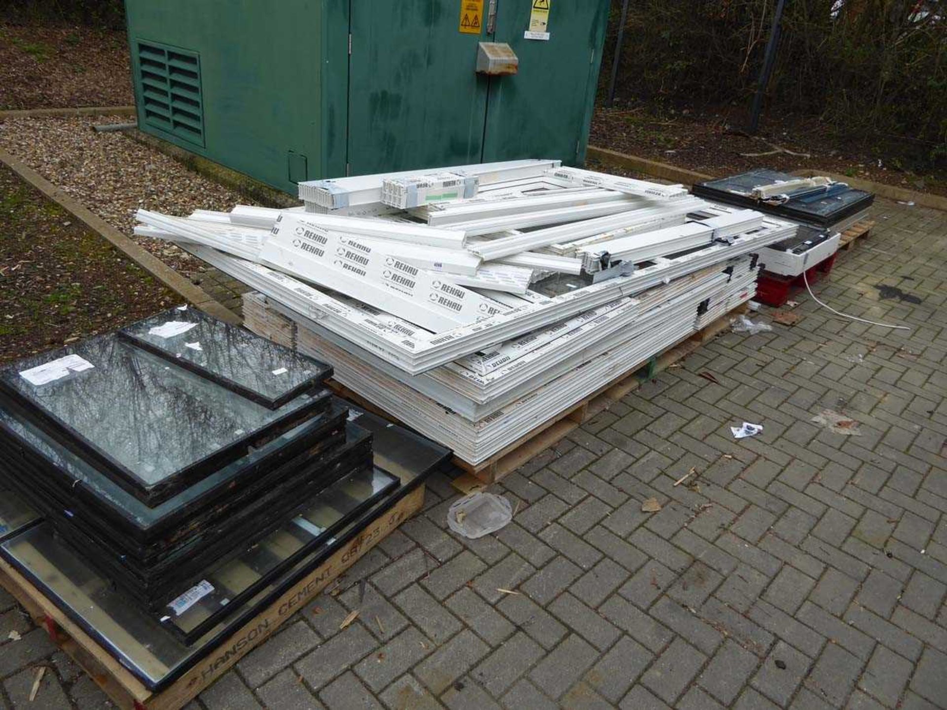 Four pallets containing various windows, glazed and unglazed, including roof window