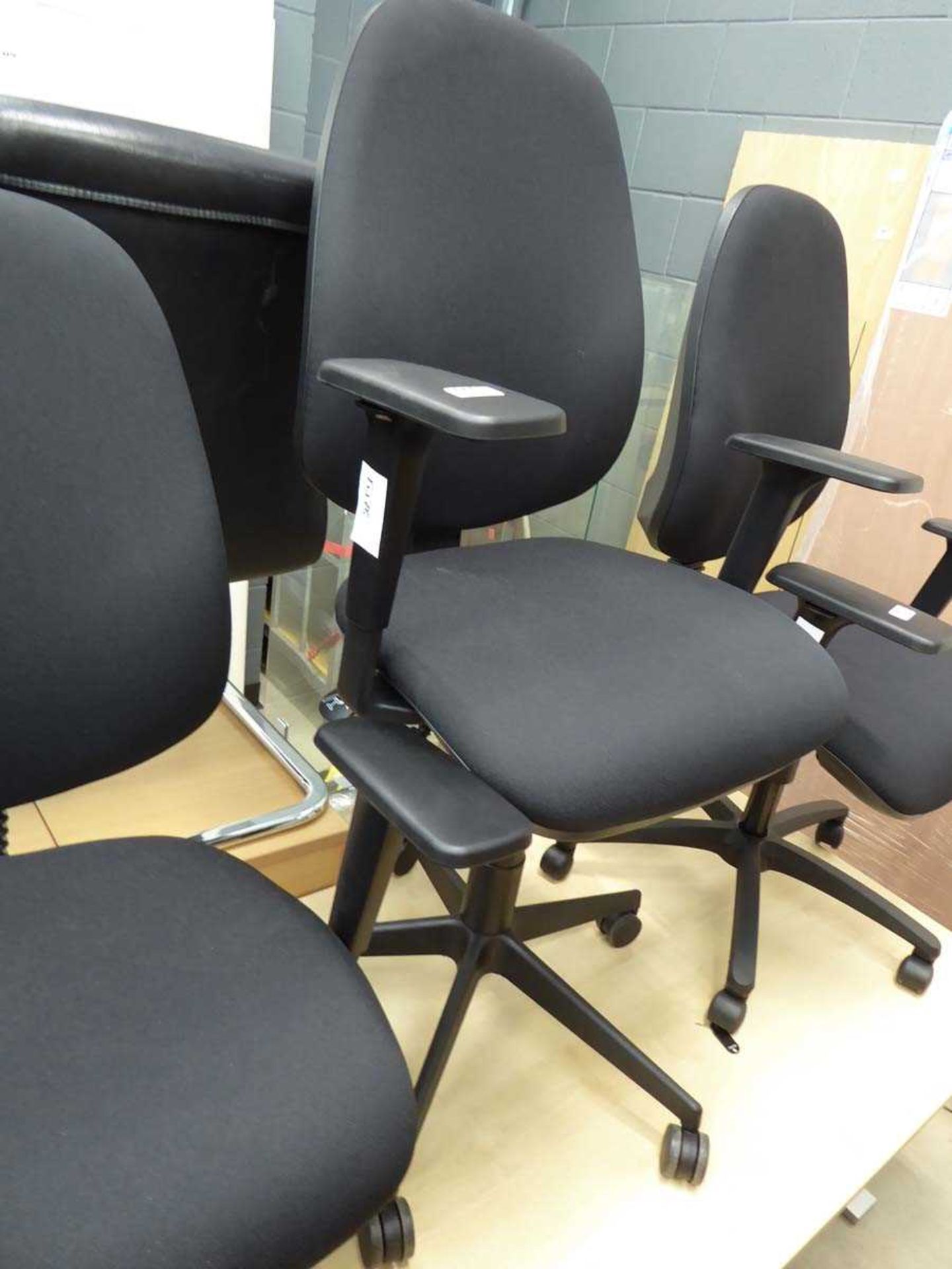 Black cloth operators swivel armchair on black base