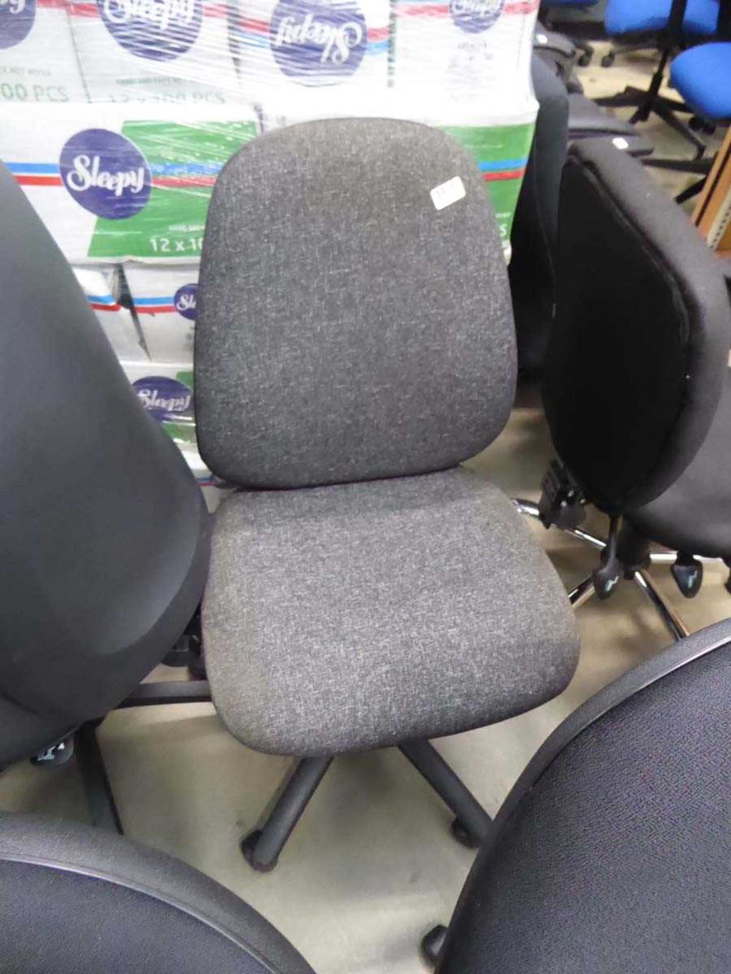 Black cloth swivel chair on black base