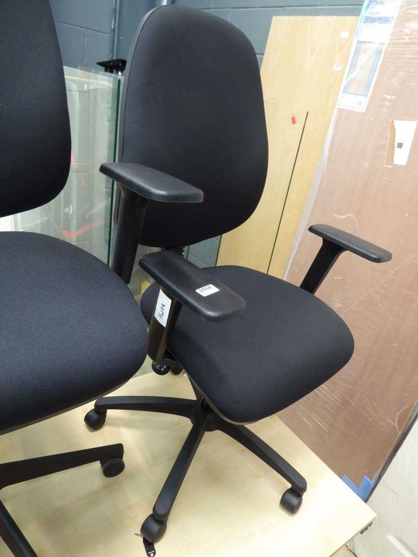 Black cloth operators swivel armchair on black base