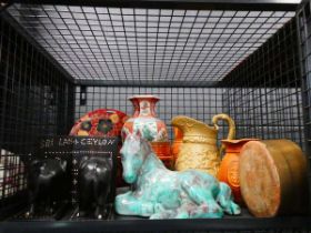 Cage containing carved elephant book ends, figure of a horse, modern oriental vase and jugs