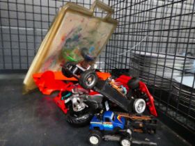 Cage containing plane tops and radio controlled cars