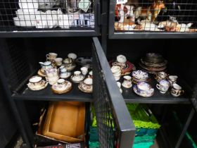 Two cages containing trios, plus other cups and saucers, various dinner plates, and milk jugs
