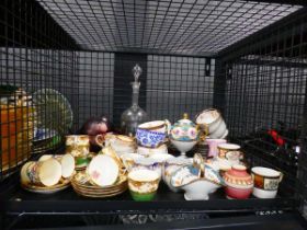 Cage containing decanter, plus rose and floral patterned crockery