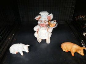 Cage containing three pig figures