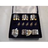 Set of 6 white metal napkin rings, with 5 white metal swans, boxed