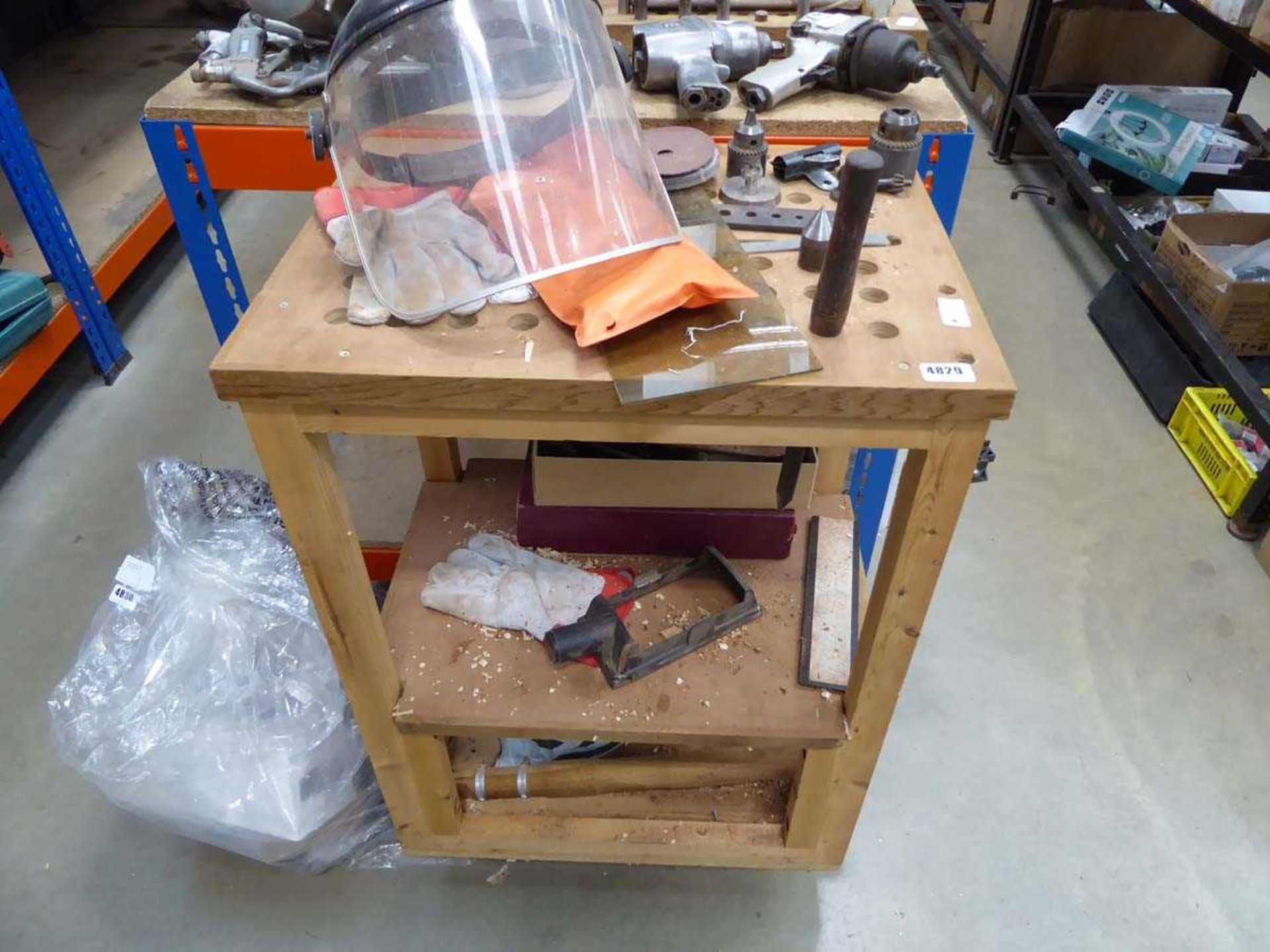 Wooden trolley containing drill heads, centres and cutting head and a mask