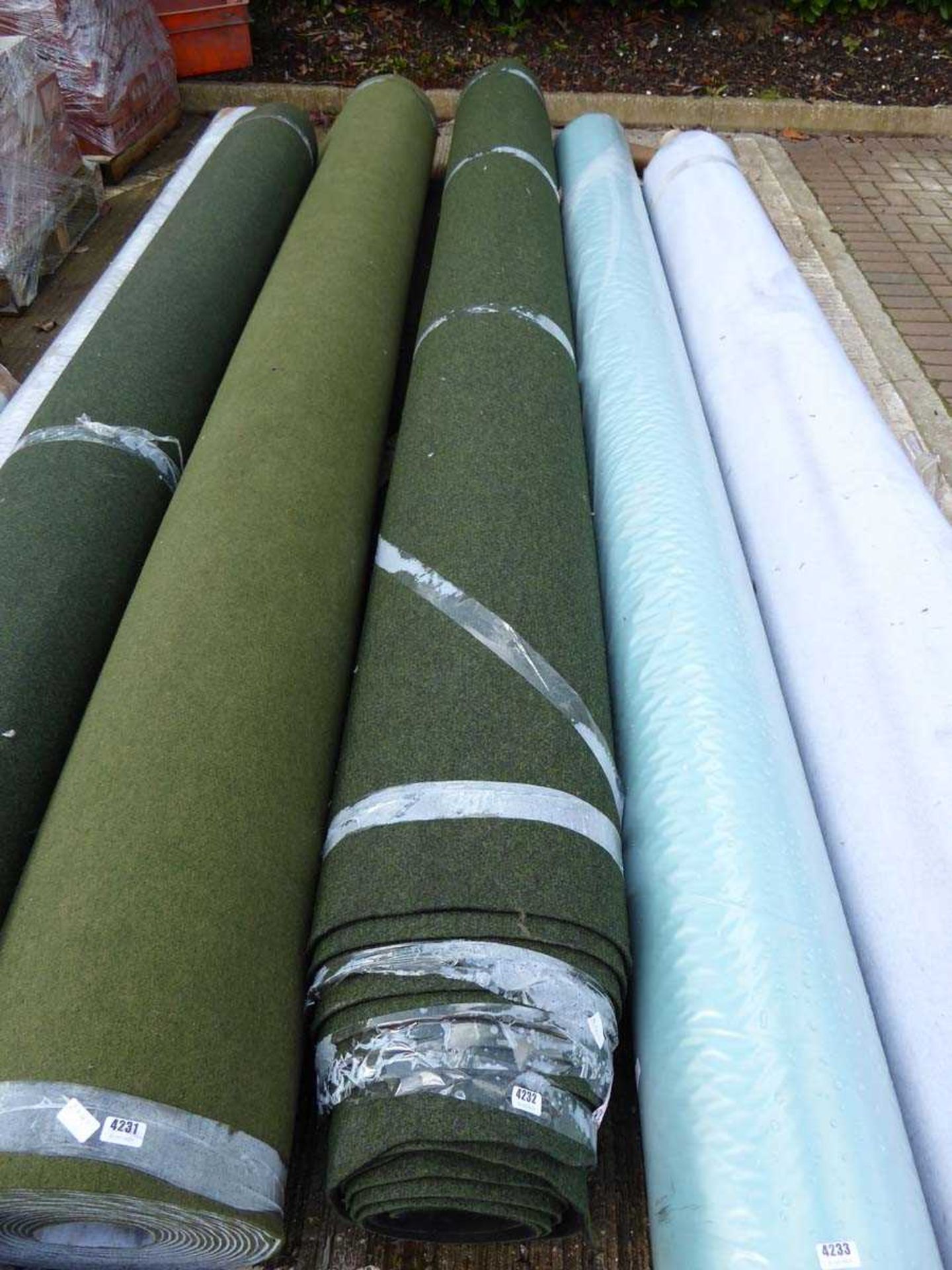 Large roll of dark green industrial style carpet