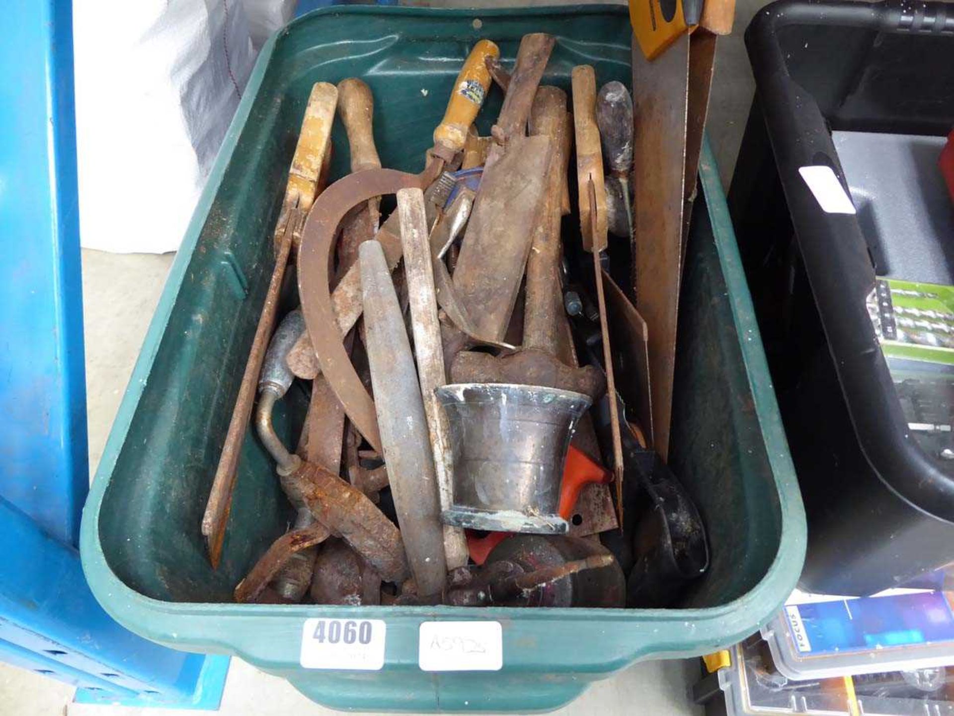 Green crate of vintage tools