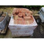 Pallet of red coloured bricks