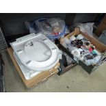 Quarter of an under bay containing toilet seats, filters, plumbing items, pipes, etc
