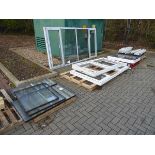 Four pallets containing various windows, glazed and unglazed, including roof window