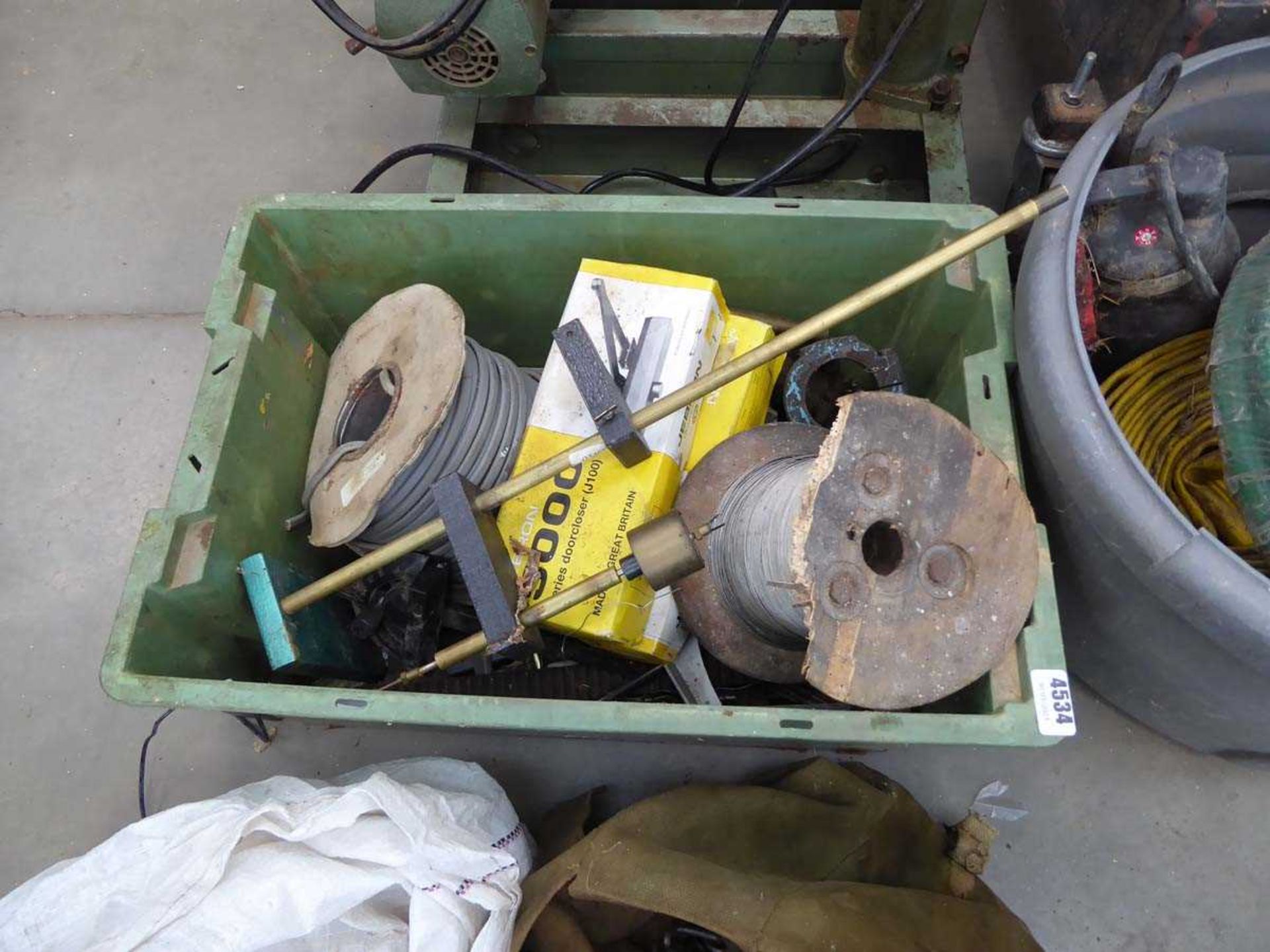 Green crate with cable, door openers, and tooling