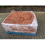 Pallet of red bricks