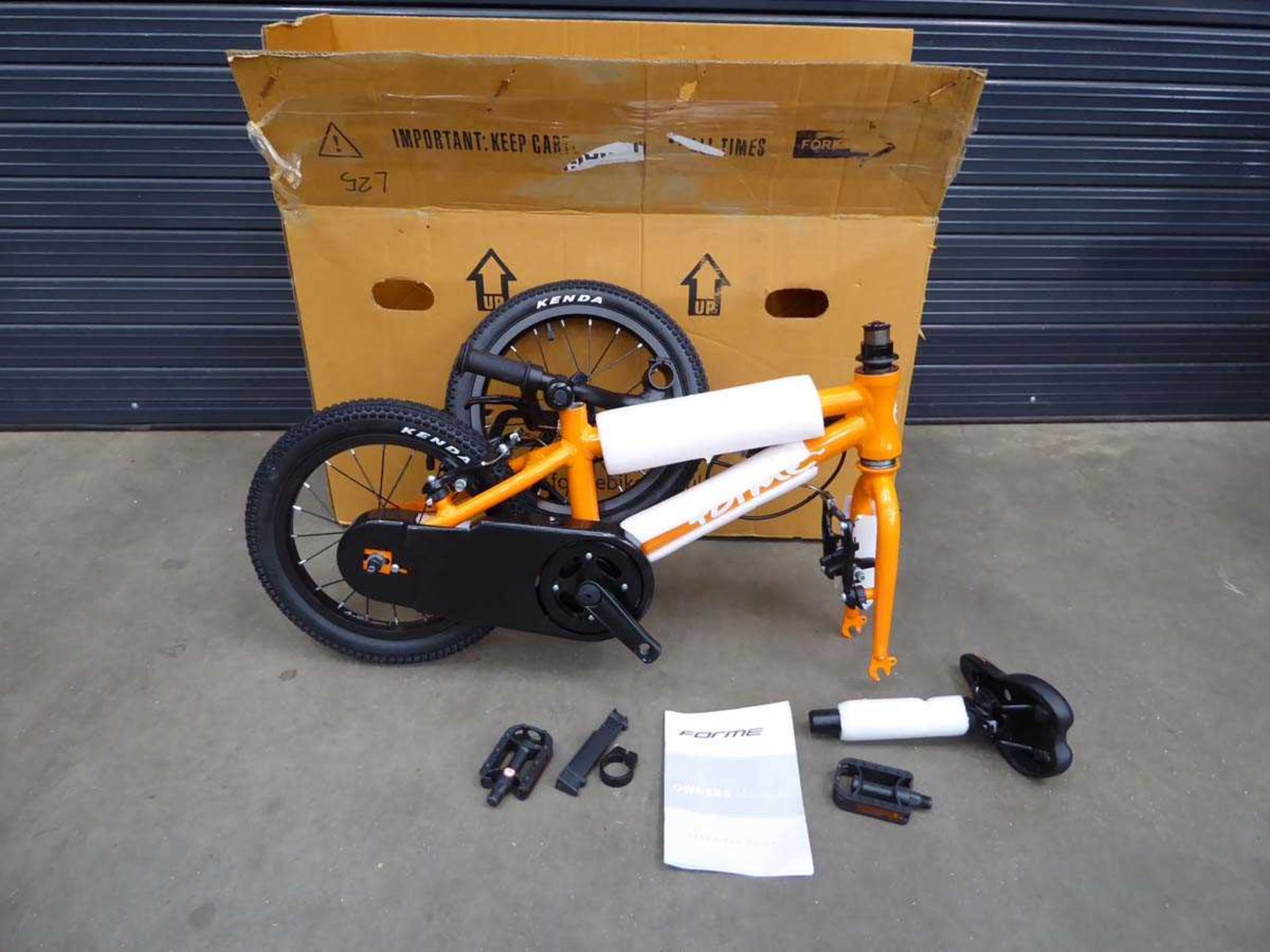 Orange small child's flatpack boxed bike
