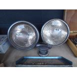 2 vintage car head lights and a fuel cap