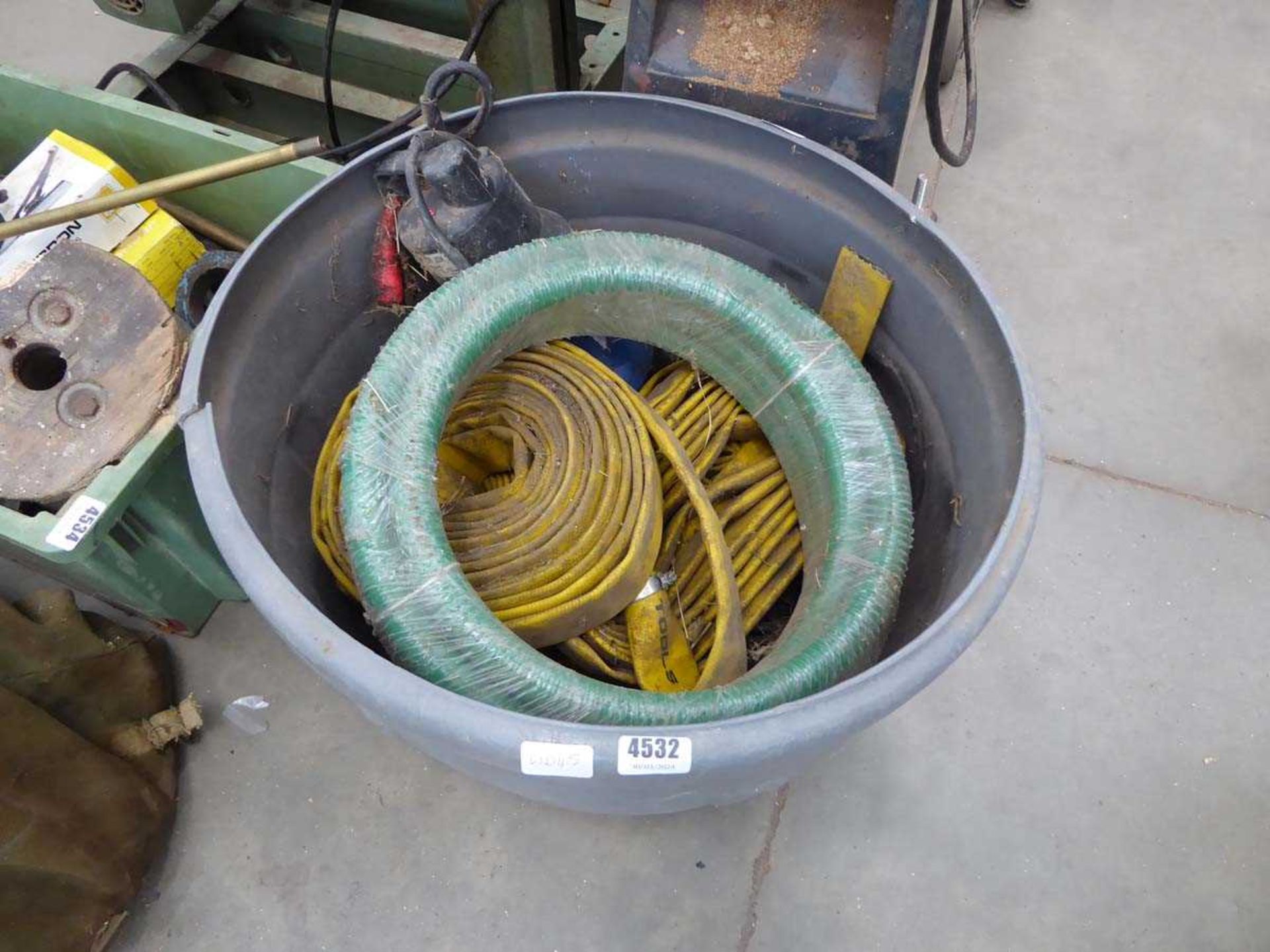 Grey bucket containing lay flat hose and sub pump