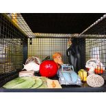 Cage containing coasters, ornamental apple, car, Poole dolphin and other figures
