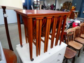 Teak table with four folding tables nesting under
