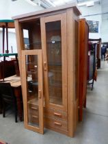 Glazed oak double door display unit with drawers under