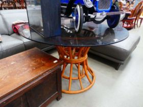 Bent cane table base with glass surface