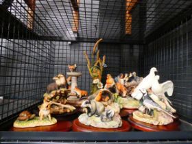 Cage containing resin figures of woodland creatures